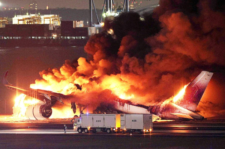 A Japan Airlines jet burns on the runway of Tokyo's Haneda Airport on Tuesday after colliding with a coast guard plane