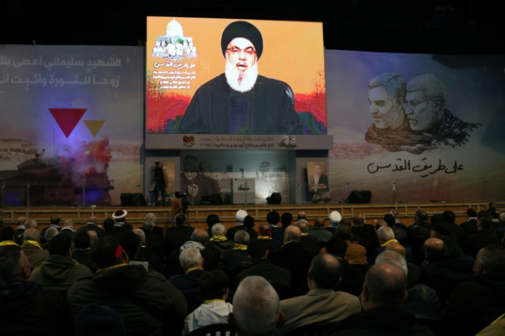 People watch the televised speech of Lebanon's Hezbollah chief Hasan Nasrallah, in southern Beirut on January 3, 2024