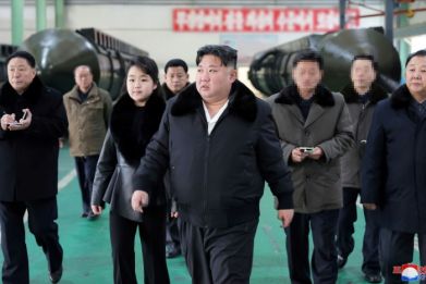 North Korea's leader Kim Jong Un (C) inspects a missile launcher production facility with his daughter Ju Ae (centre L)