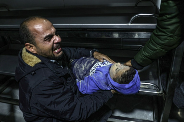 A relative  at the European hospital in Khan Yunis mourns over the body of a 12-year-old boy killed along with his immediate family during Israeli bombardment