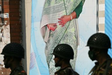 Soldiers stand in front of a portrait Prime Minister Sheikh Hasina in Dhaka on January 6: her government's intolerance towards dissent has given rise to resentment at home and expressions of concern from Washington and elsewhere abroad
