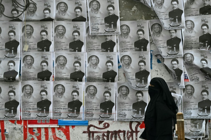 A woman walks past posters of Hasina's Awami League party: Bangladesh, one of the world's poorest countries when it gained independence, has grown an average of more than six percent each year since 2009