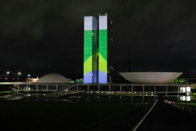 A Brazilian flag is projected on the country's National Congress in Brasilia on January 7, 2023, one day before the first anniversary of a revolt in which supporters of far-right former president Jair Bolsonaro stormed government buildings