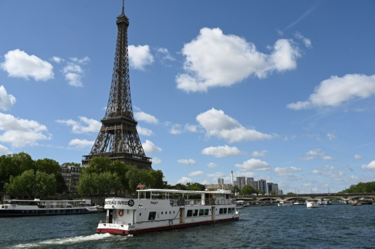 A boat sails past the Eiffel Tower on the River Seine during tests for the 2024 Olympics opening ceremony