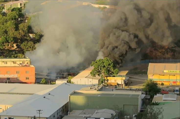 Smoke billows from a building fire in Port Moresby after riots erupted that left 15 dead