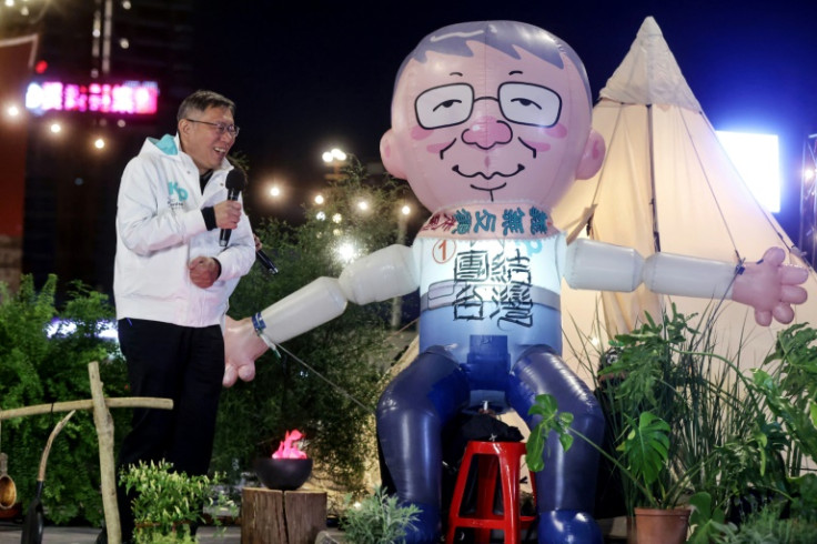 Presidential candidate Ko Wen-je reacts to a giant inflatable balloon resembling him at a Taiwan People's Party event