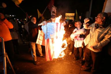 Iranian protesters burn a US flag during a demonstration in solidarity with the Palestinian people and Iran-backed Yemeni rebels following the US and British strikes on Huthi rebel targets