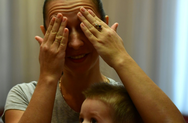 Anna Demkina with her two-year old son in their temporary accommodation after evacuating from Belgorod