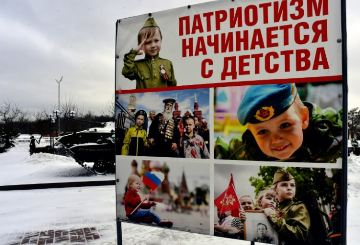 A patriotic banner in Stary Oskol's main square shows children dressed in military uniform
