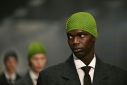 Prada brightened up dour work suits with beany hats in purple, bright red and apple green