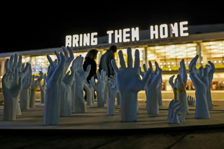 An art installation calling for the release of Israeli hostages held in Gaza is seen near a sign reading 'Bring Them Home' in Tel Aviv