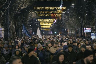 Opposition supporters march in Belgrade Tuesday to protest against last month's elections