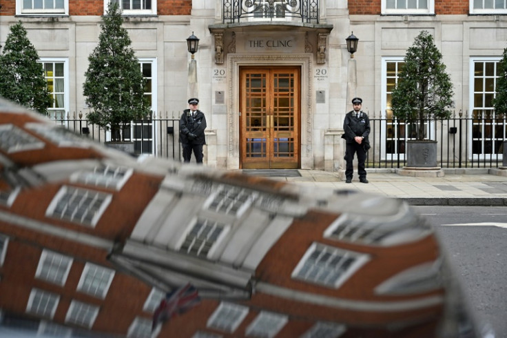 Police officers stand guard outside The London Clinic where the princess was admitted