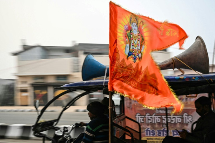An electric rickshaw driver flies a flag depicting Hindu deity Ram  in Ayodhya on December 28