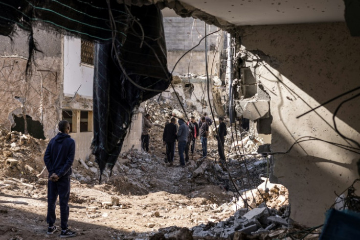 Residents stand outside a destroyed house in the Nur Shams refugee camp in Tulkarem on Thursday after an Israeli army operation