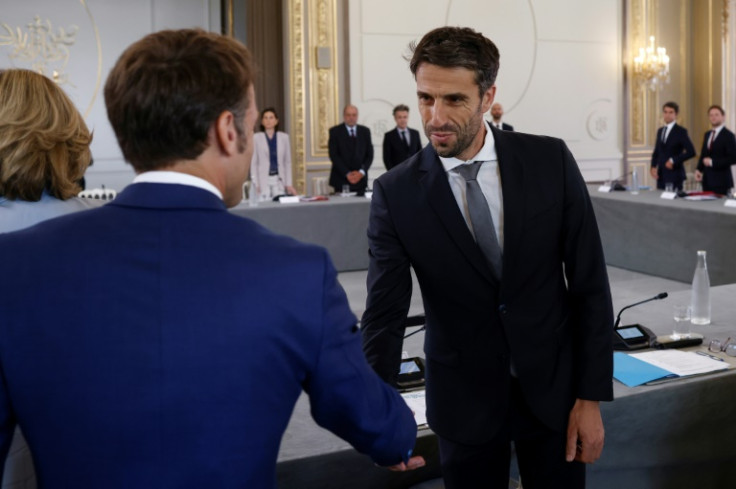 Chief organiser Tony Estanguet, seen here greeting President Emmanuel Macron, says the French tend to focus on the negative