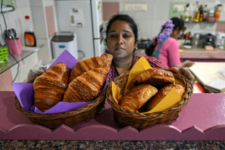 An employee prepares croissants at the 'Eat My Cake' bakery in Puducherry, 70 years after the French left the territory