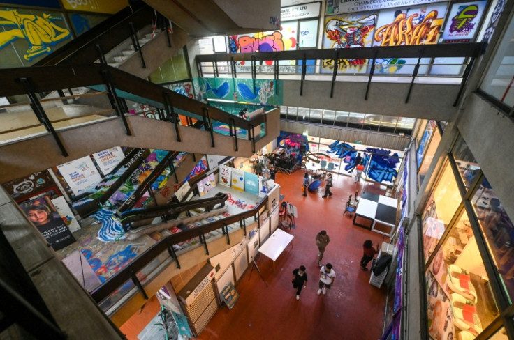 People attend graffiti workshops while punters browse through second-hand clothing stalls and exhibits at the Peace Centre