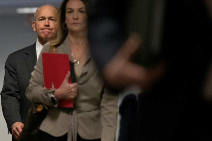 Boeing CEO Dave Calhoun (L) arrives on Capitol Hill in Washington, DC, on January 24, 2024, to meet with a group of senators