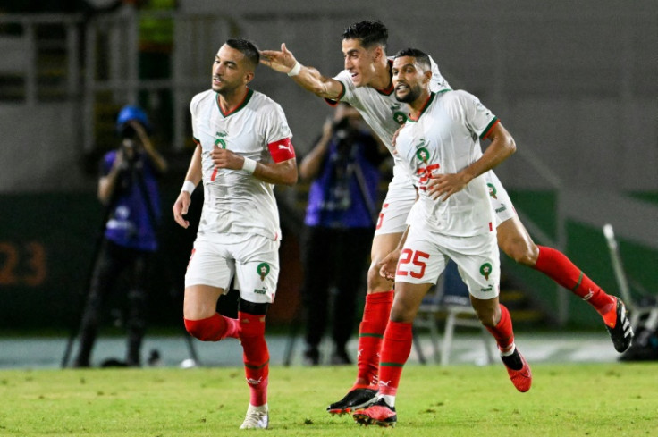 Hakim Ziyech (L) celebrates with his Morocco teammates after scoring against Zambia