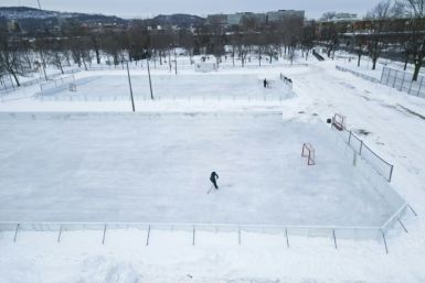A hockey player skates on one of the few open outdoor ice rinks at Laurier Park in Motnreal