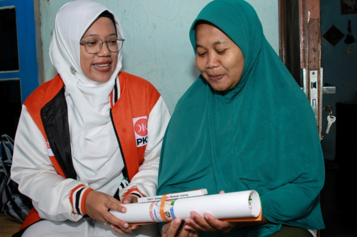 Legislative candidate Lingga Permesti (L) is one of several women hoping the February 14 election will produce a shakeup of Indonesia's parliament