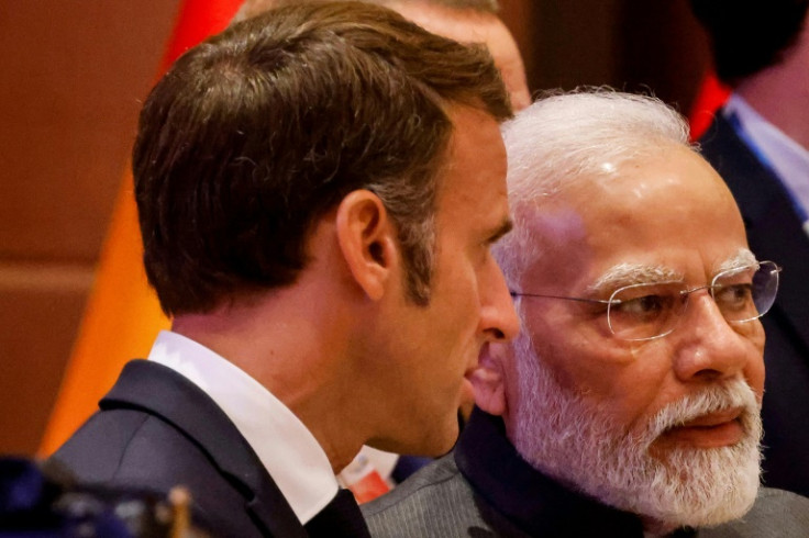 India's Prime Minister Narendra Modi (R) speaks with France's President Emmanuel Macron when he he was last in India in September during the G20 summit in New Delhi
