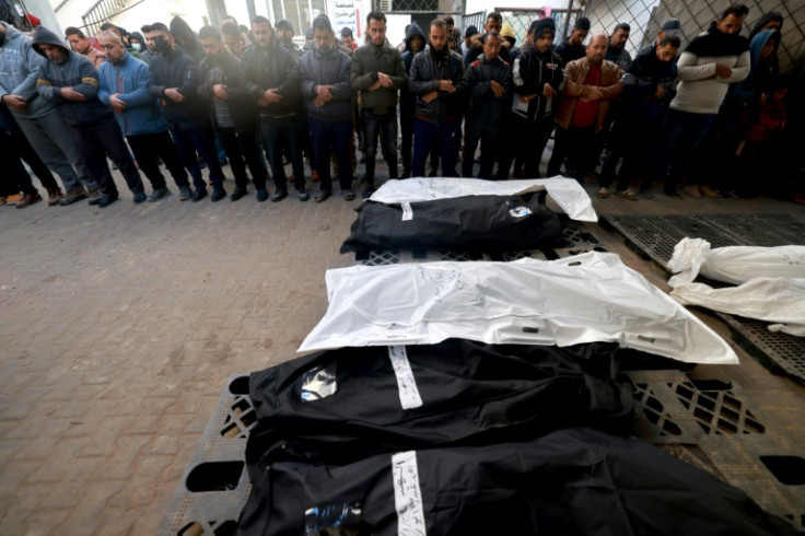 Palestinian mourners pray over the bodies of relatives killed in Israeli bombardments in Khan Yunis in the south of the Gaza Strip