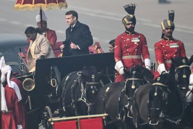 Indian President Droupadi Murmu (L) and French President Emmanuel Macron (C) arrive for India's 75th Republic Day parade