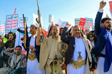 Supporters of Yemen's Huthis brandish rifles during an anti-Israel and anti-US rally