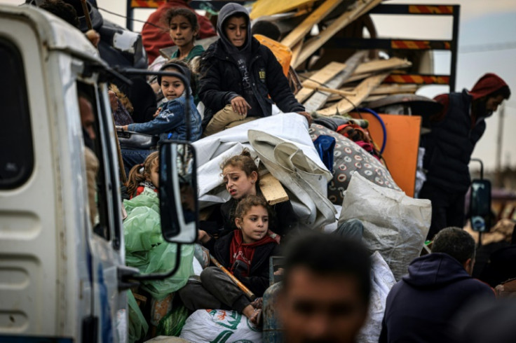 Palestinians carry their belongings as they flee Khan Yunis in the southern Gaza Strip