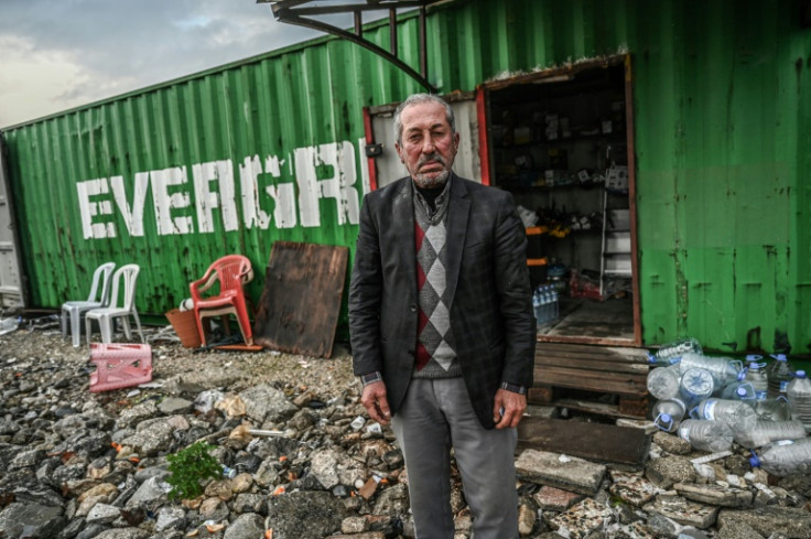 Sislioglu sells his remaining shop wares out of a metal container to feed his family