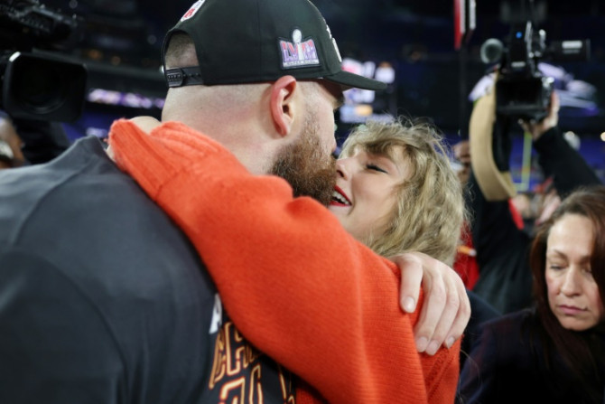 Kansas City tight end Travis Kelce shares a kiss with girlfriend Taylor Swift after the Chiefs booked a return to the Super Bowl with a victory over the Baltimore Ravens