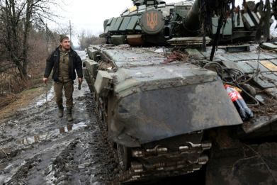 A Ukrainian tankman is seen next to his tank on the road in Donetsk region, on January 27, 2024