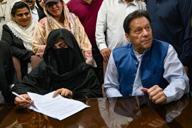 Former Pakistani prime minister Imran Khan (R) and his wife Bushra Bibi (L) have been sentenced to 14 years in jail over graft