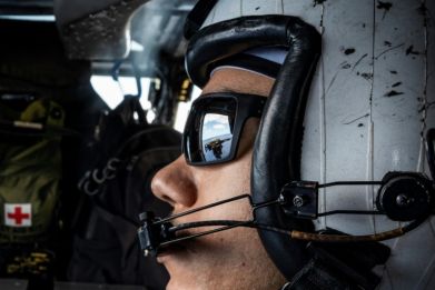 A crew member aboard a helicopter launched from the USS Carl Vinson during joint US-Japanese drills