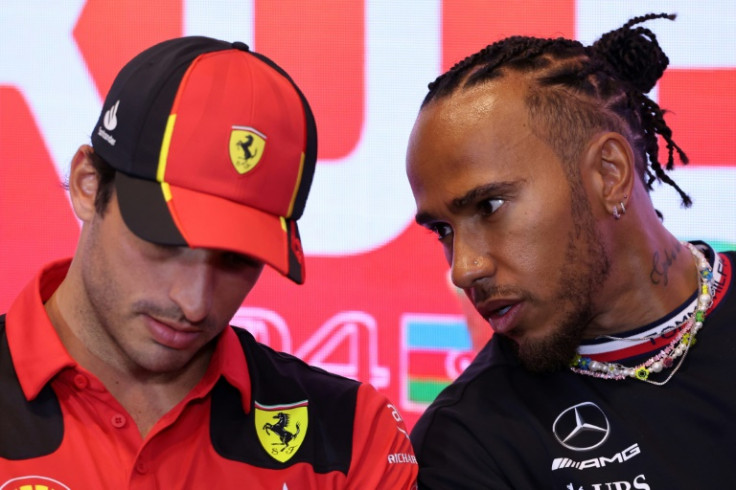 Hot seats: Ferrari's Carlos Sainz (L) and Lewis Hamilton chat at the Formula One Azerbaijan Grand Prix last April