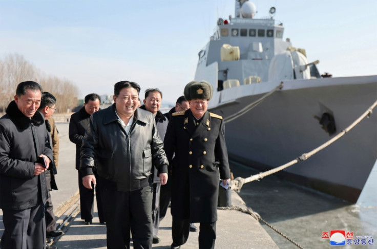 North Korean leader Kim Jong Un (C) inspects warships at the Nampho Dockyard
