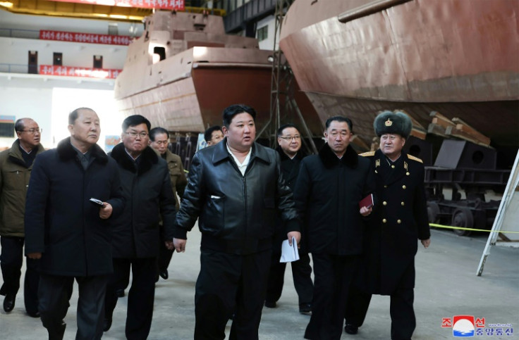 Kim Jong Un (C) told officials that strengthening North Korea's navy was key to 'stepping up war preparations'