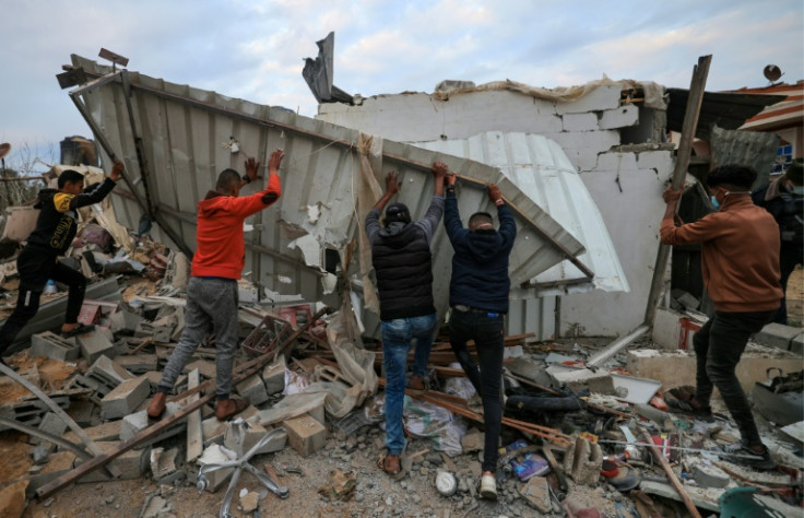 Gazans look for survivors in the rubble of the Abu Saleh family home in Rafah after it was hit during Israeli bombardment