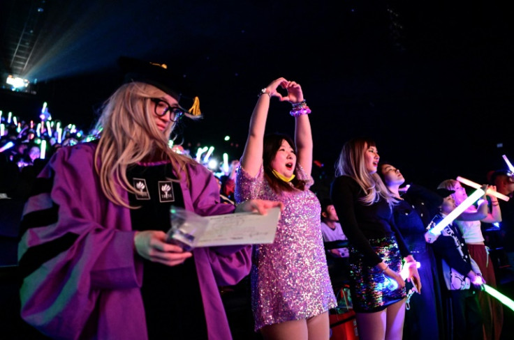 Fans waving glow sticks, holding signs, and wearing sequin dresses and other costumes have packed Beijing cinemas to watch Taylor Swift's "Eras" tour documentary