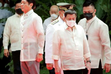 Incoming Philippine President Ferdinand Marcos Jr (L) and outgoing President Rodrigo Duterte (C) take part in the inauguration ceremony for Marcos at the Malacanang presidential palace grounds in Manila on June 30, 2022