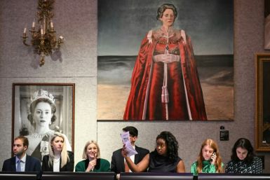 Members of staff take calls of bidders during the 'The Crown Auction' in London
