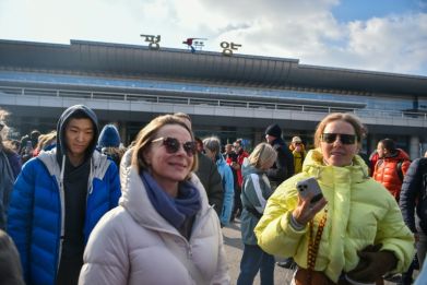 A group of Russian tourists walk outside after their arrival at Pyongyang International Airport in Pyongyang on February 9, 2024. A group of Russian tourists arrived in Pyongyang on February 9, AFP reporters saw, the first known foreign tour group to visi