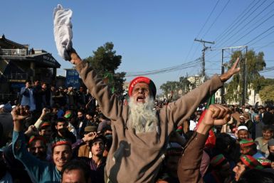 Supporters of Pakistan Tehreek-e-Insaf (PTI) protest outside a temporary election commission office in Peshawar. PTI leaders claim they would have won even more seats if not for vote rigging