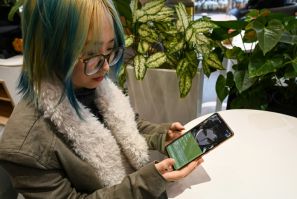 Wang Xiuting talks to her virtual boyfriend on Wantalk - an artificial intelligence chatbot created by Chinese tech company Baidu, on her phone at a cafe in Beijing