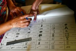A woman marks a ballot paper with a fingerprint in Karachi during national and provincial elections in Pakistan last week