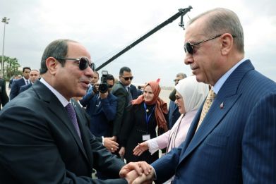 Egyptian President Abdel Fattah al-Sisi greets his Turkish counterpart Recep Tayyip Erdogan at Cairo International Airport