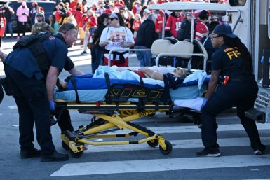 An injured person is loaded on an ambulance near the Kansas City Chiefs' Super Bowl LVIII victory parade on February 14, 2024