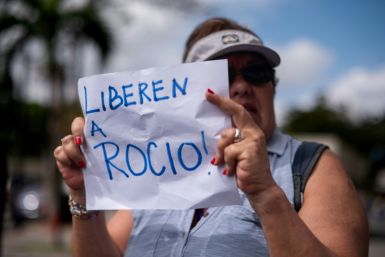 A woman holds a sign that reads "Release Rocio" during a protest demanding her release